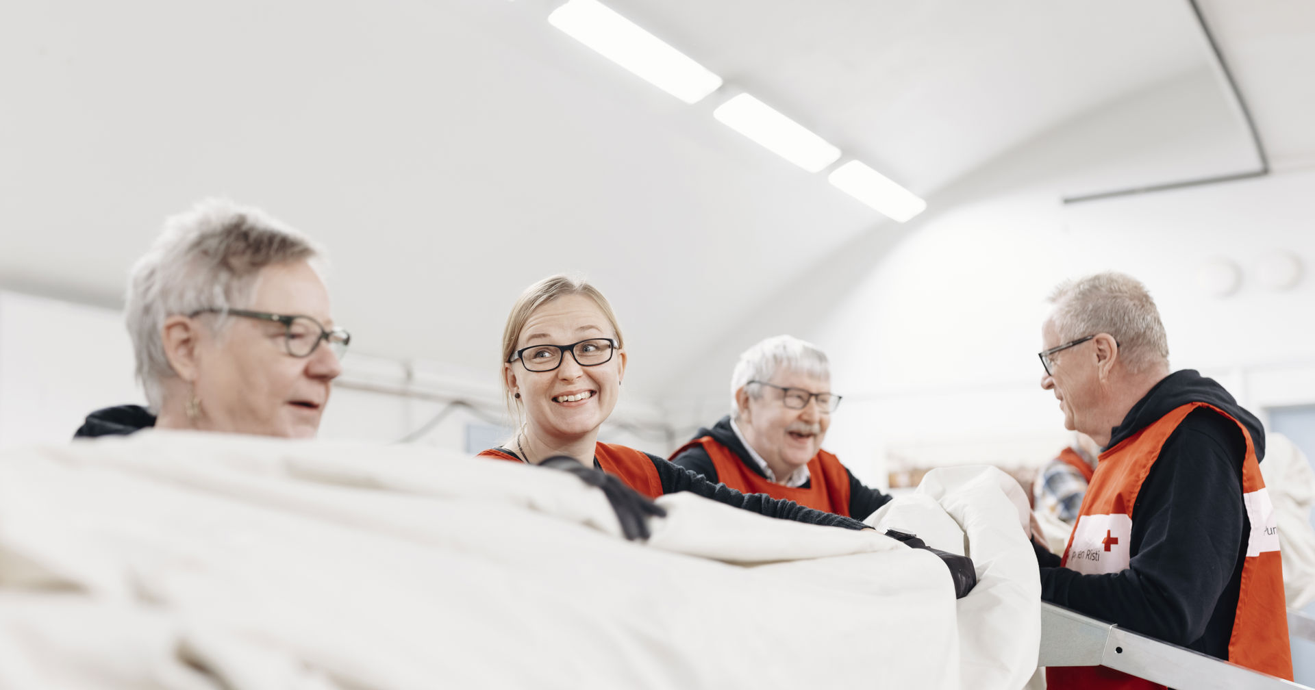 Vapaaehtoisia kokoamassa suurta telttaa.